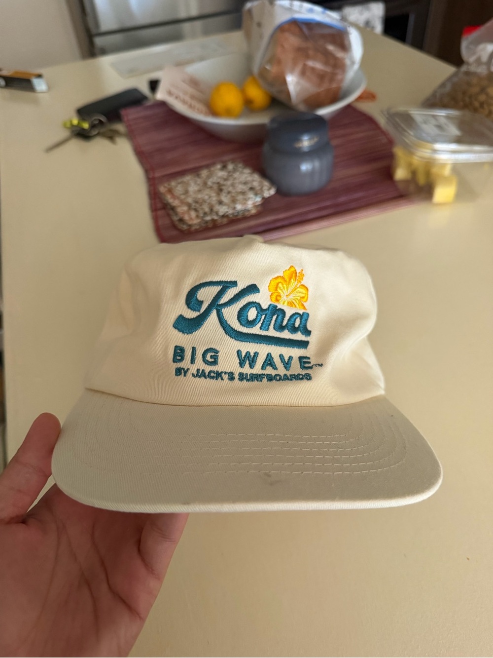 Kona Big Wave Cream Baseball Cap with Teal Logo and Yellow Flower